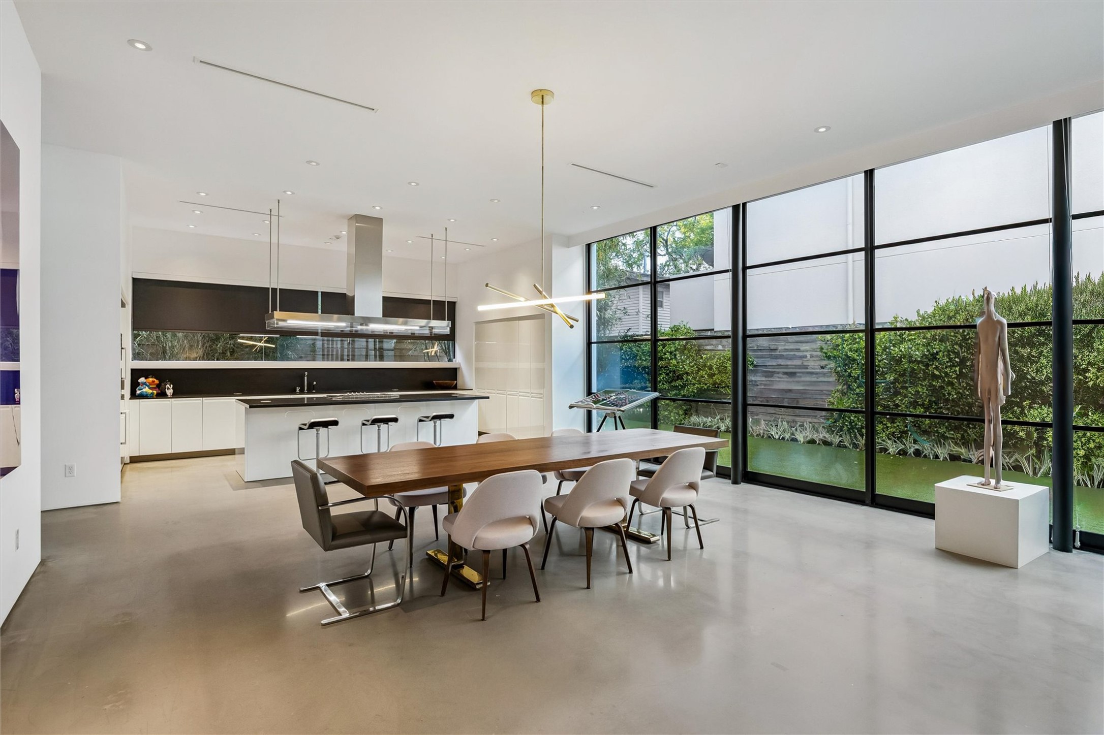 1527 Indiana Street Houston, TX 77006 - Photo 8 of 30 Floor-to-ceiling walls of sliding door and windows overlook the backyard.