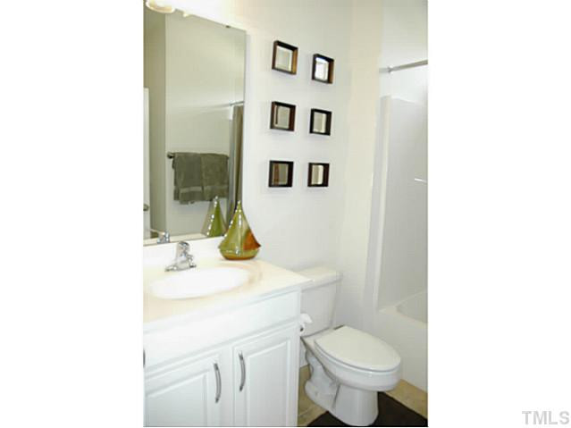 702 Ivyshaw Road Cary, NC 27519 - Photo 11 of 25 Full bath on main floor. Door opens to hallway, and another door opens to the guest bedroom. Bathroom