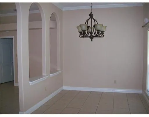 a view of a hallway with wooden floor and cabinet