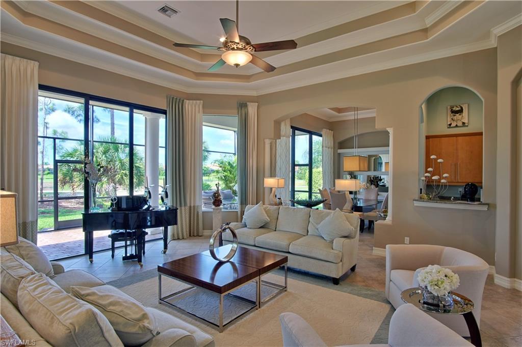 7389 Byrons Way Naples, FL 34113 - Photo 12 of 35 a living room with furniture ceiling fan and a window