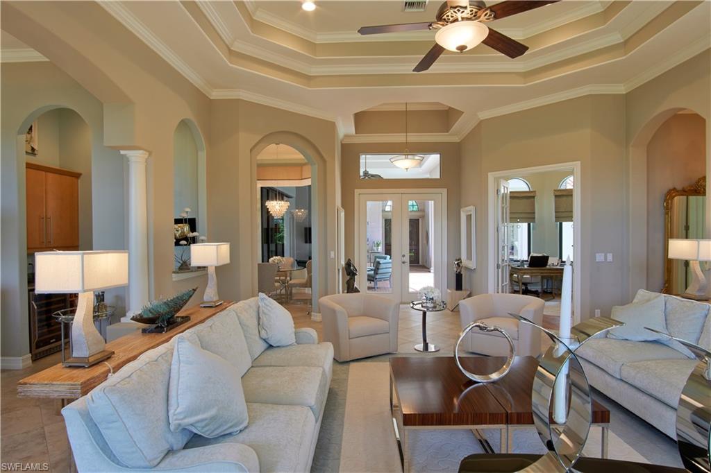 7389 Byrons Way Naples, FL 34113 - Photo 15 of 35 a living room with furniture and a chandelier