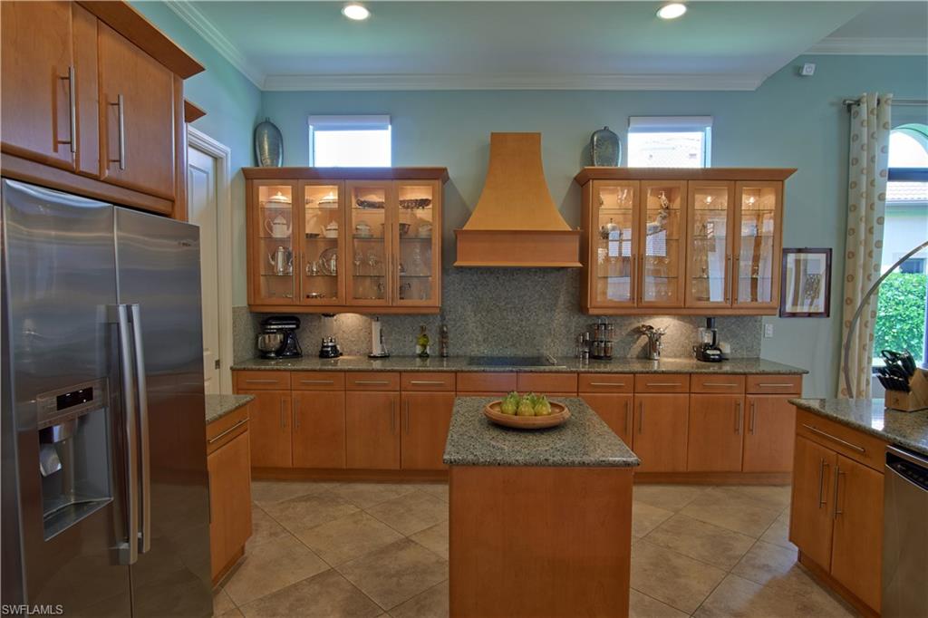 7389 Byrons Way Naples, FL 34113 - Photo 21 of 35 a kitchen with stainless steel appliances granite countertop a sink stove and refrigerator