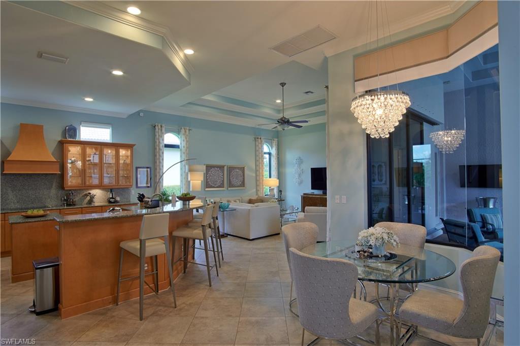 7389 Byrons Way Naples, FL 34113 - Photo 22 of 35 a living room with fireplace furniture and a chandelier