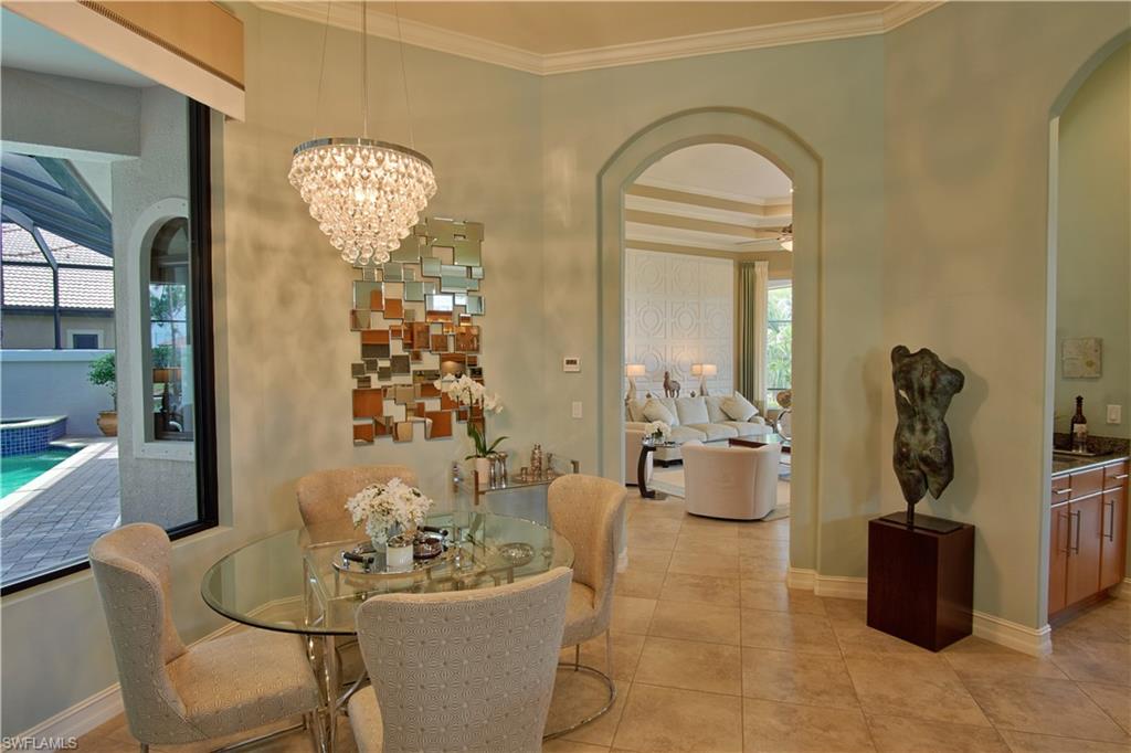 7389 Byrons Way Naples, FL 34113 - Photo 24 of 35 a dining room with furniture and chandelier