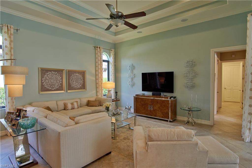 7389 Byrons Way Naples, FL 34113 - Photo 25 of 35 a living room with furniture and a flat screen tv