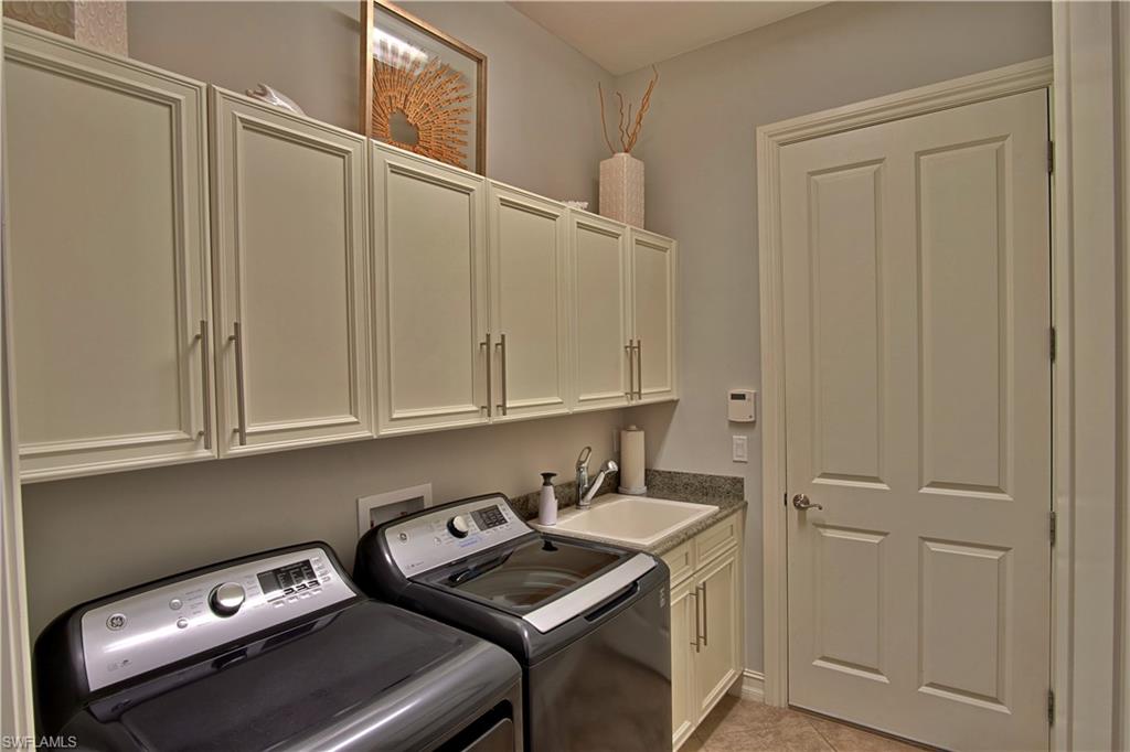 7389 Byrons Way Naples, FL 34113 - Photo 32 of 35 a room with storage and utility