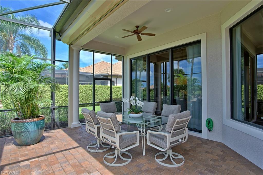 7389 Byrons Way Naples, FL 34113 - Photo 33 of 35 a living room with patio furniture and a potted plant
