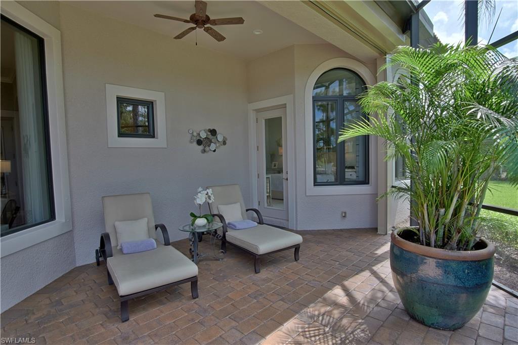 7389 Byrons Way Naples, FL 34113 - Photo 34 of 35 a living room with furniture and a potted plant