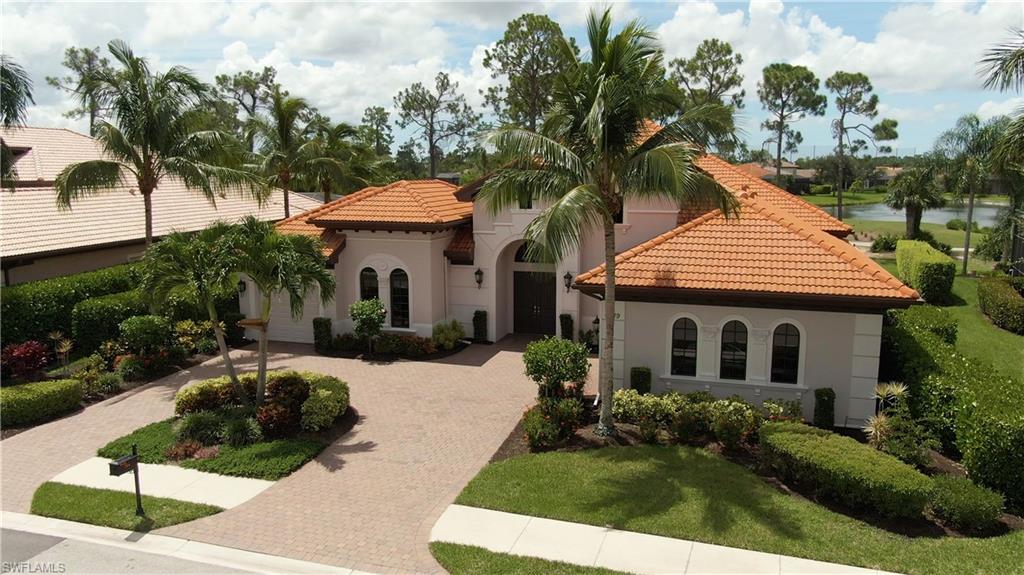 7389 Byrons Way Naples, FL 34113 - Photo 4 of 35 a front view of a house with a yard