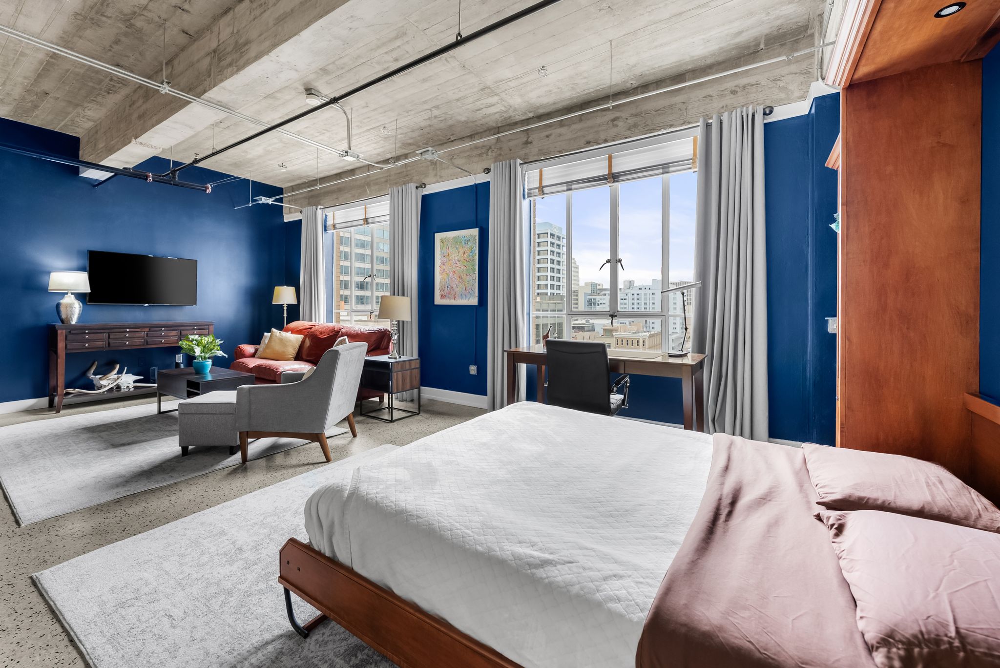 710 Colorado Street, Unit 6E Austin, TX 78701 - Photo 15 of 24 An open-concept living space with city views, featuring high ceilings and a versatile layout.