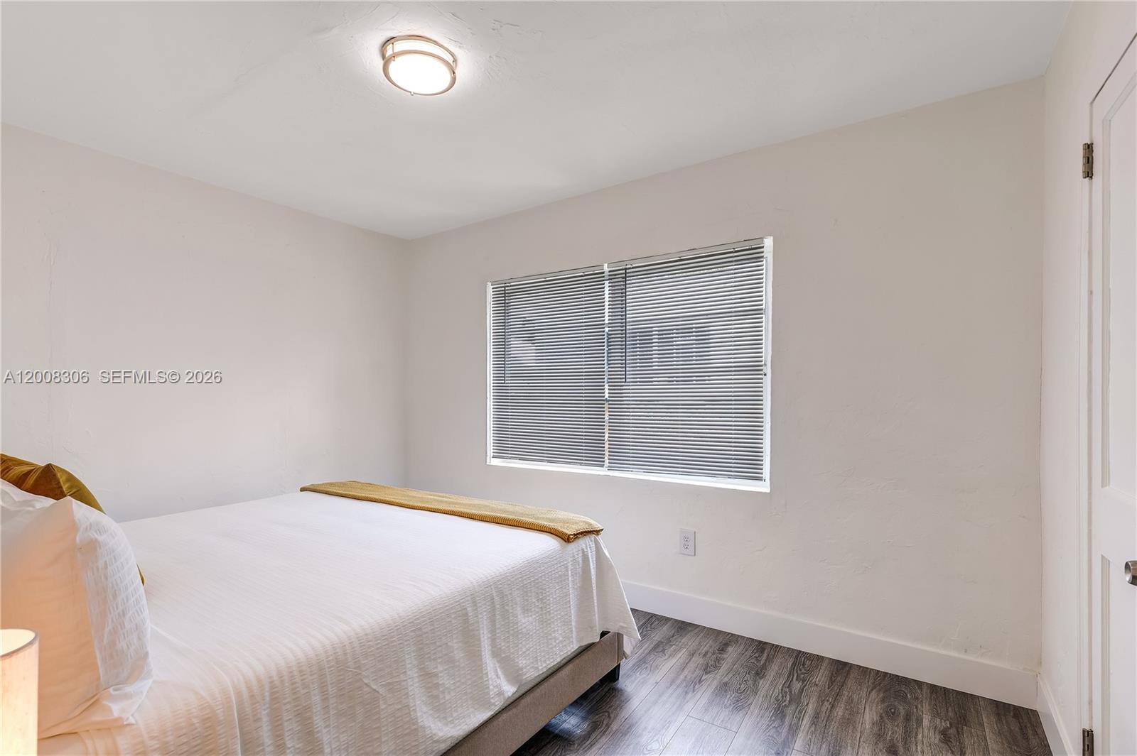 327 Northeast 55th Street, Unit 2 Miami, FL 33137 - Photo 11 of 14 a bedroom with a bed and a window