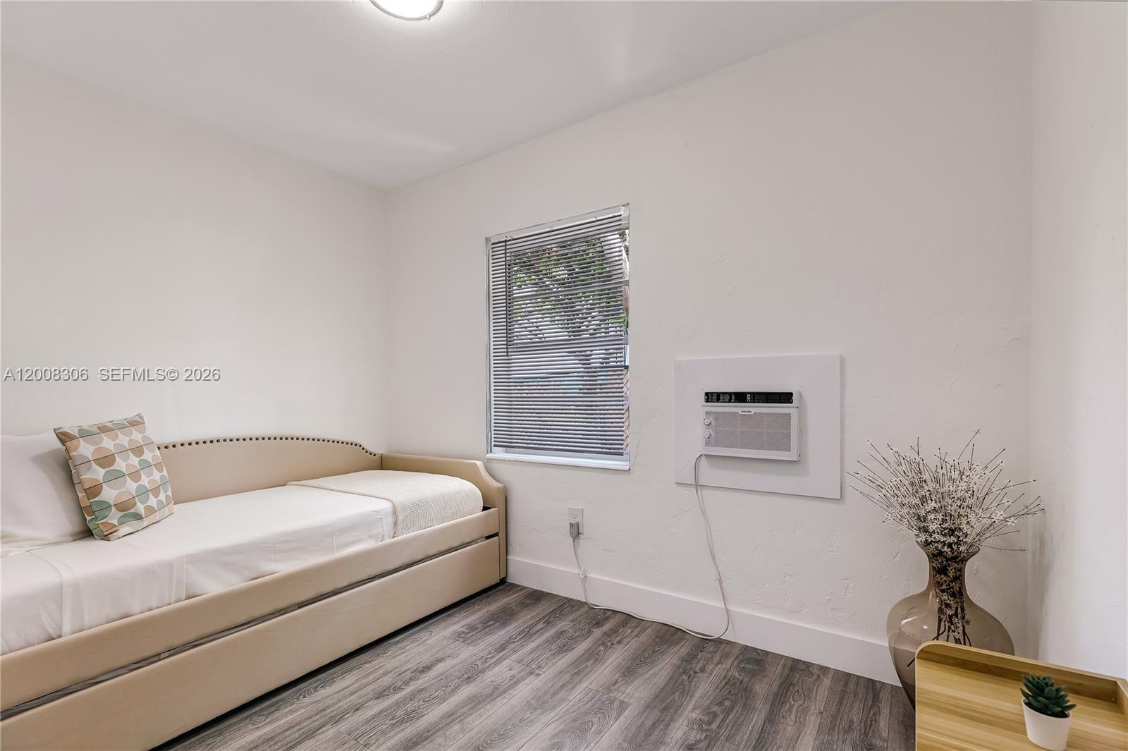 327 Northeast 55th Street, Unit 2 Miami, FL 33137 - Photo 12 of 14 a room with a bed and a potted plant