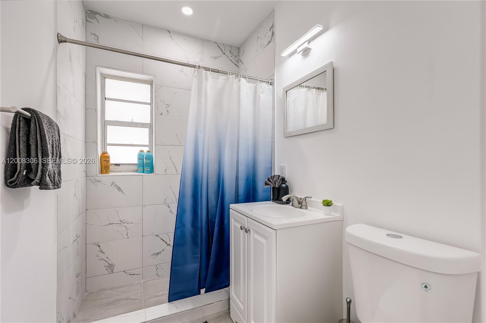 327 Northeast 55th Street, Unit 2 Miami, FL 33137 - Photo 13 of 14 a bathroom with a sink a toilet and shower