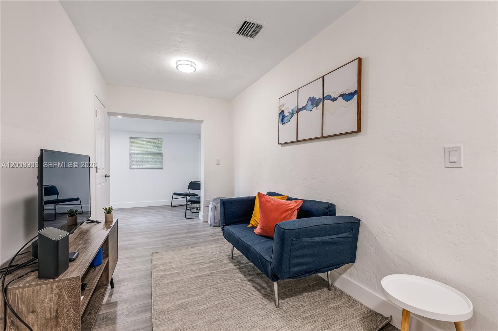 327 Northeast 55th Street, Unit 2 Miami, FL 33137 - Photo 2 of 14 a room with furniture and screen