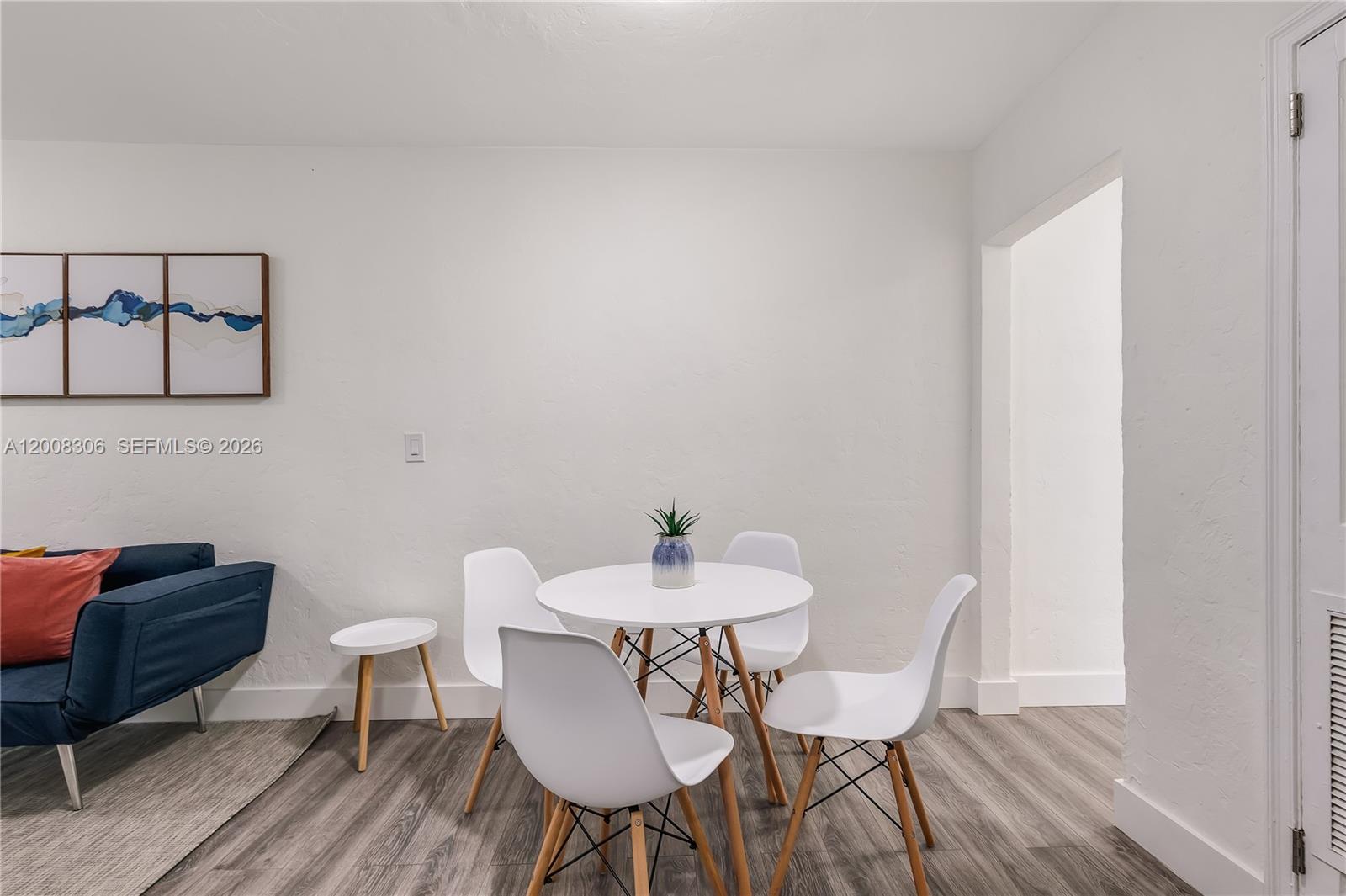 327 Northeast 55th Street, Unit 2 Miami, FL 33137 - Photo 5 of 14 a dining room with furniture and wooden floor