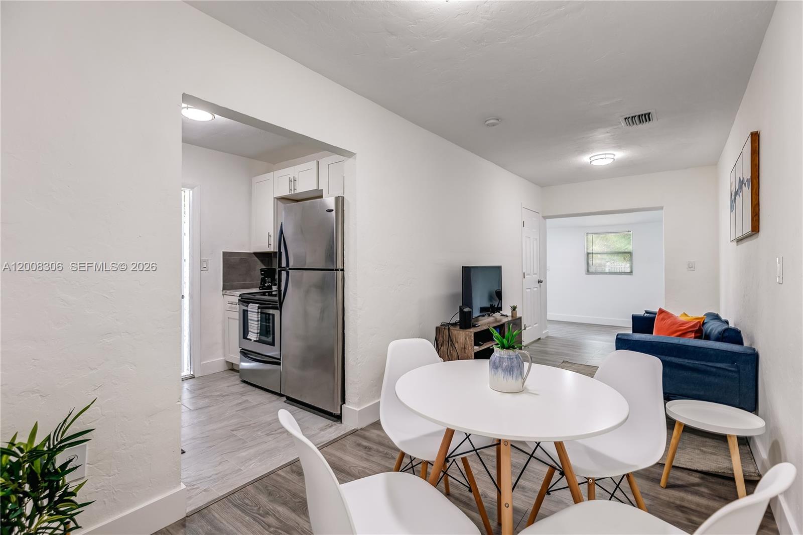 327 Northeast 55th Street, Unit 2 Miami, FL 33137 - Photo 9 of 14 a living room with furniture and kitchen view