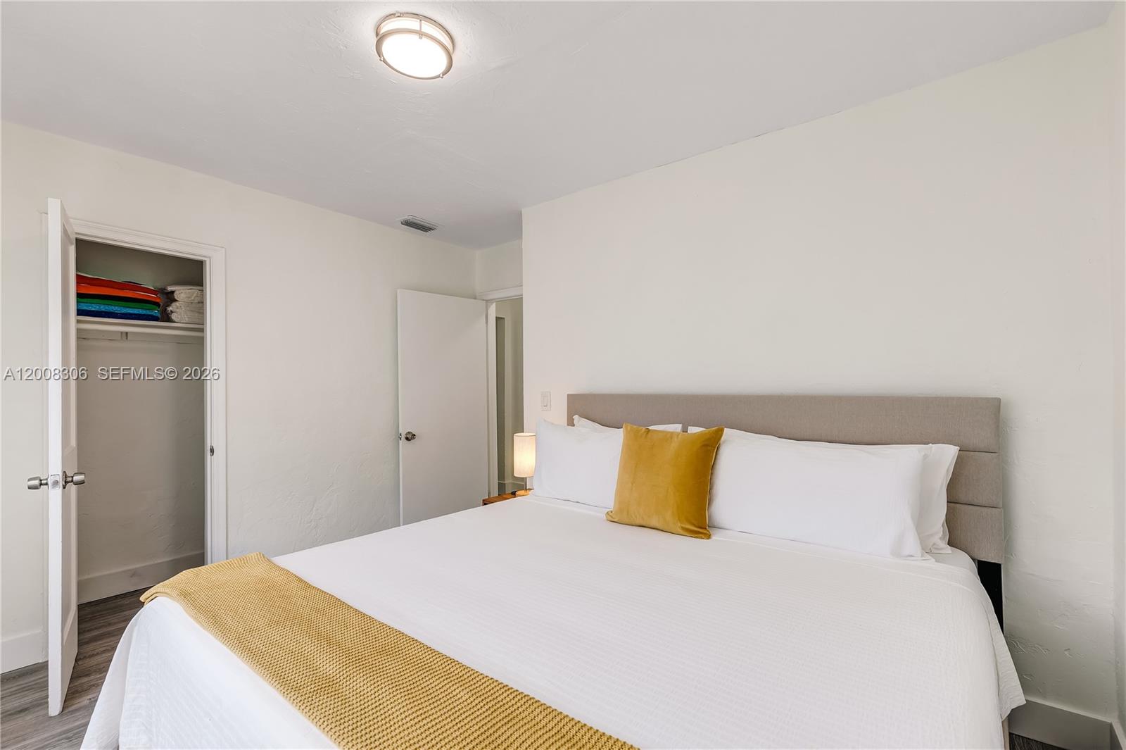 327 Northeast 55th Street, Unit 2 Miami, FL 33137 - Photo 10 of 14 a bedroom with a bed and a night stand