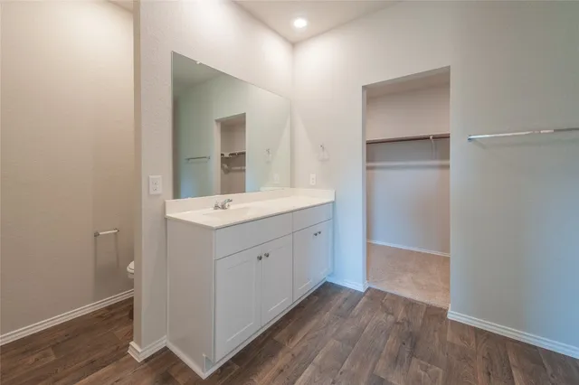a bathroom with a sink vanity and a mirror