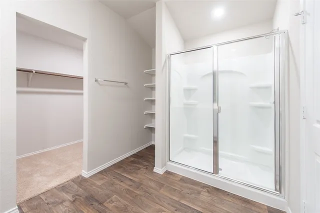 a bathroom with a glass shower door