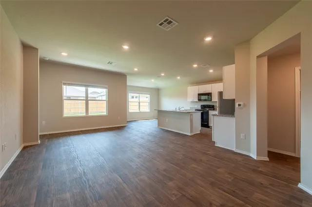 a view of kitchen with sink and wooden floor