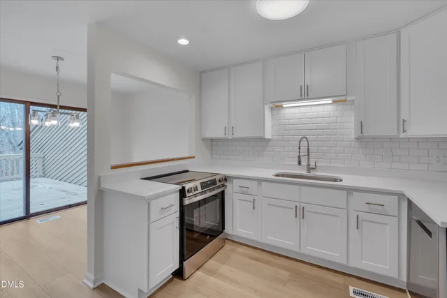 a kitchen with appliances cabinets and a sink