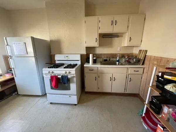 a kitchen with a stove and a refrigerator