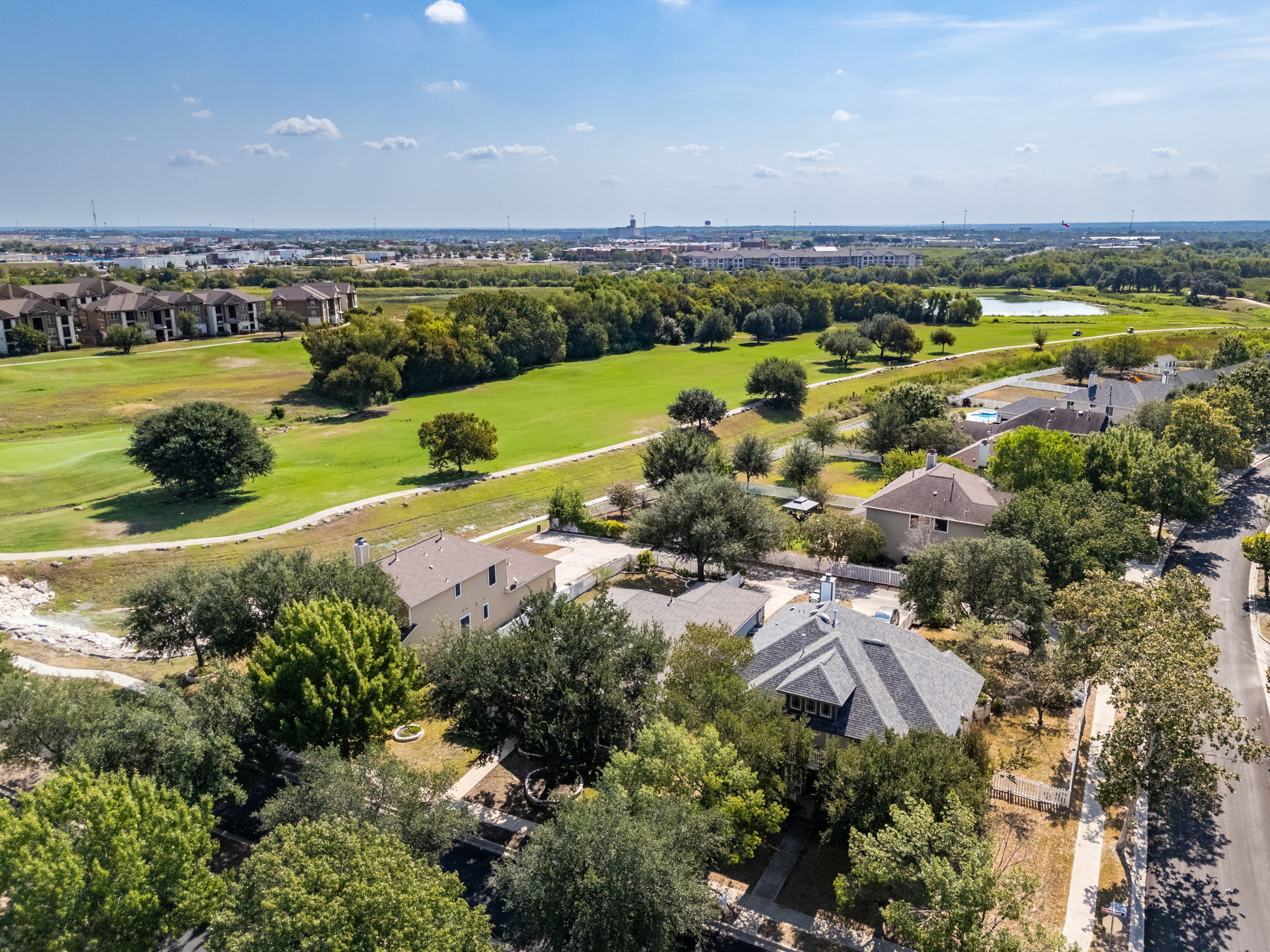 784 Sampson Kyle, TX 78640 - Photo 37 of 40 An aerial perspective captures the neighborhood setting bordering lush green spaces under blue skies.