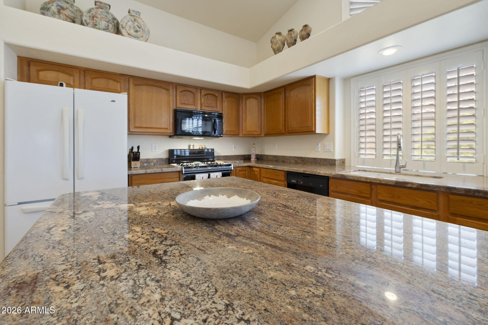 12435 West Monte Vista Road Avondale, AZ 85392 - Photo 20 of 69 a kitchen with a sink and a stove top oven