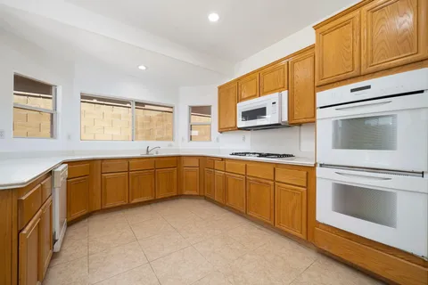 a kitchen with stainless steel appliances granite countertop a refrigerator sink and cabinets