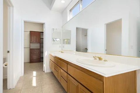 a bathroom with a tub sink and mirror