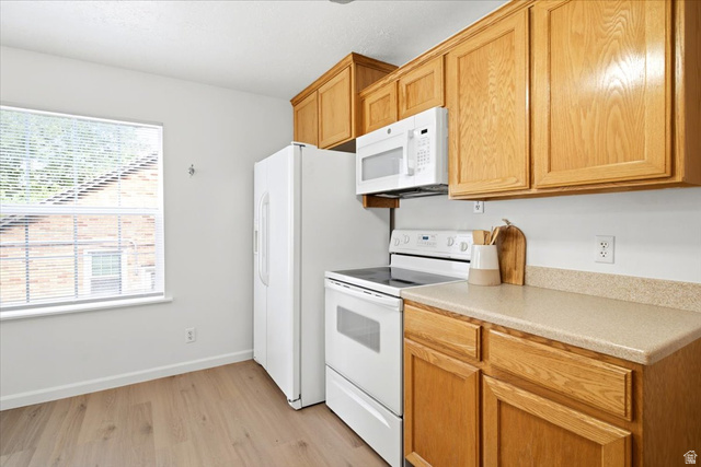 1341 29th Street Ogden, UT 84403 - Photo 11 of 37 Kitchen featuring wood-finish cabinetry and light-toned countertops