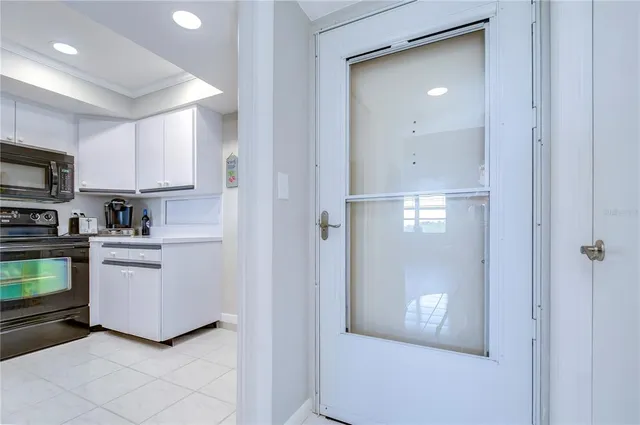 a kitchen with kitchen island granite countertop a sink dishwasher stove and refrigerator with wooden cabinets