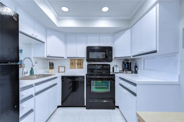 a kitchen with cabinets stainless steel appliances and a sink