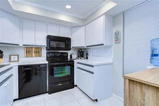 a kitchen with stainless steel appliances kitchen island a refrigerator and cabinets