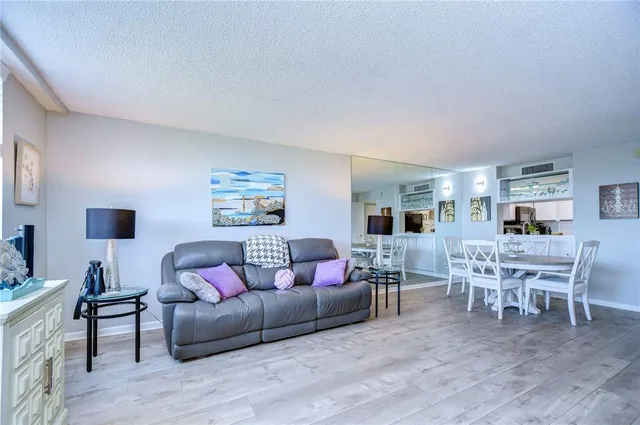 a bedroom with a bed a table and painting on the wall