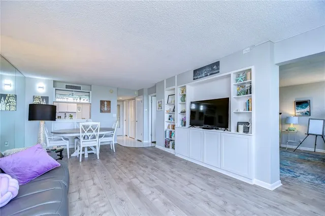 a bedroom with a large bed and a flat tv screen on dresser