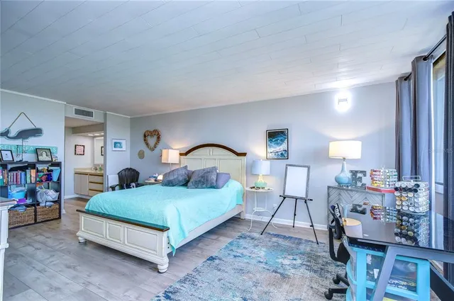 a bedroom with a large bed and a window