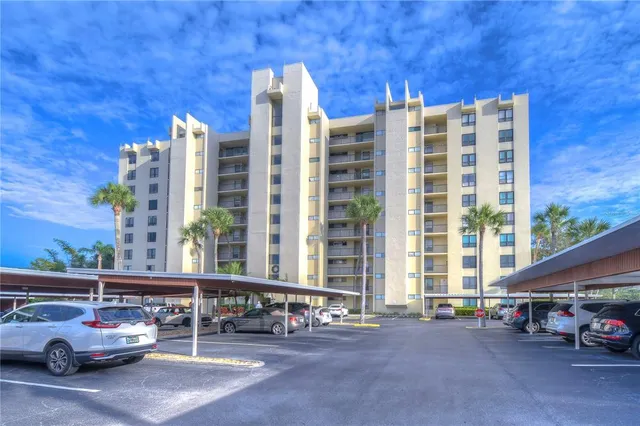 a view of a lake with a big yard and large trees