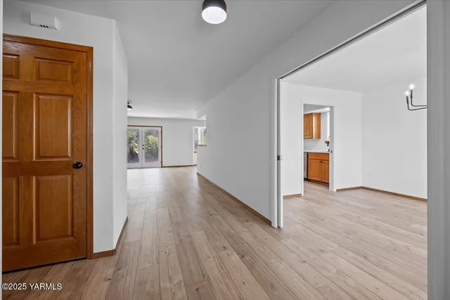 a view of a hallway with wooden floor
