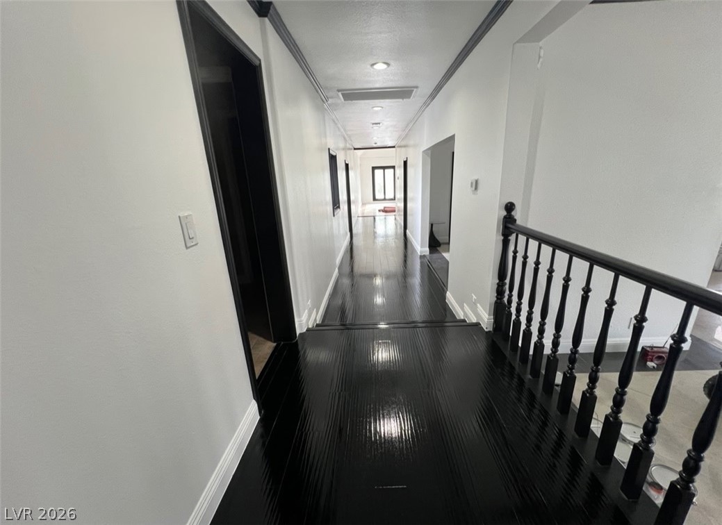 3003 Regency Hill Henderson, NV 89014 - Photo 9 of 13 A lustrous, dark wood floor guides the eye through this elegant hallway with classic architectural details.