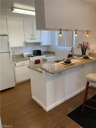 a kitchen with stainless steel appliances granite countertop a sink stove and cabinets
