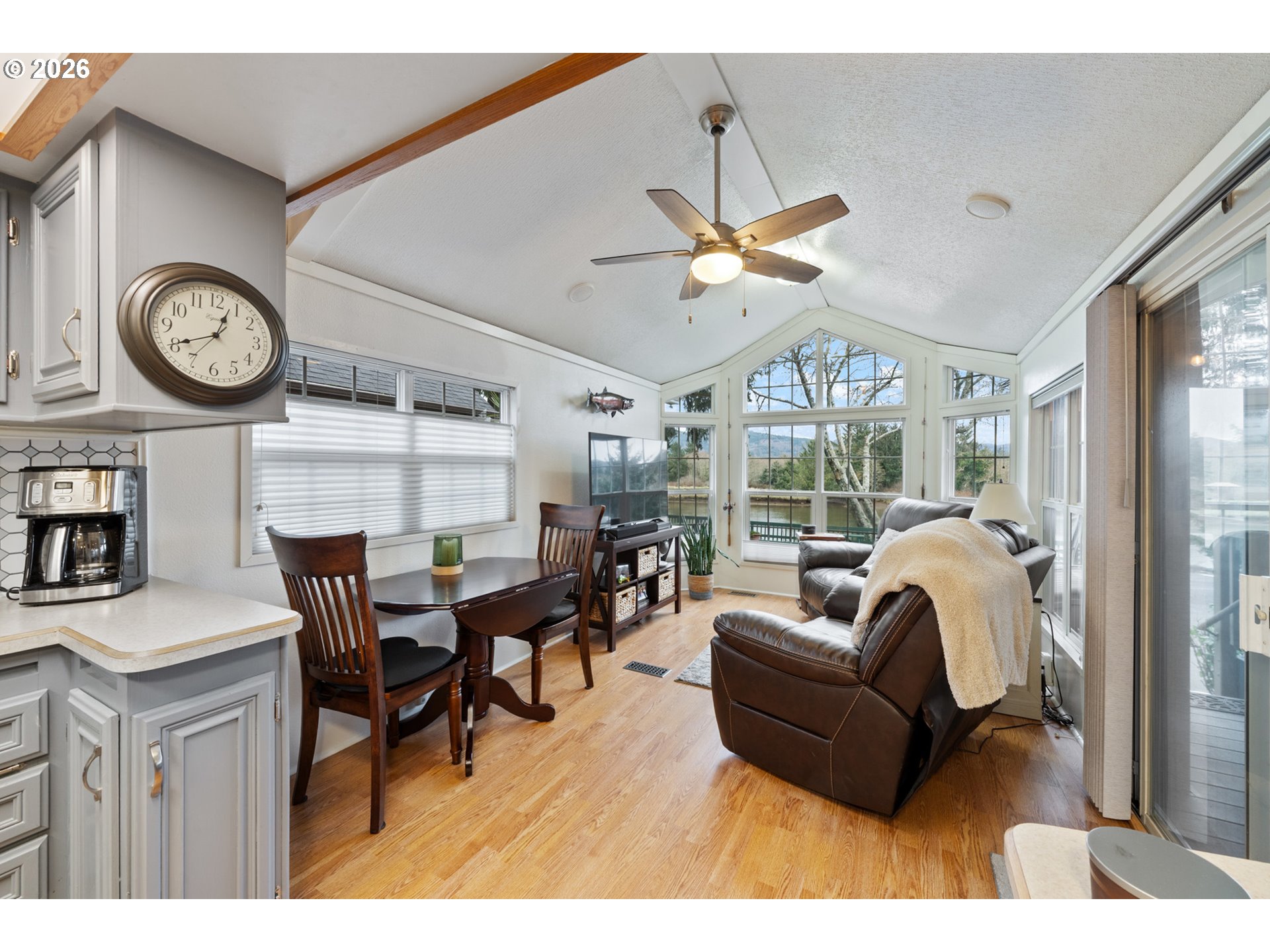 37395 North Fork Road, Unit 13 Nehalem, OR 97131 - Photo 11 of 34 a living room with furniture a clock and a large window