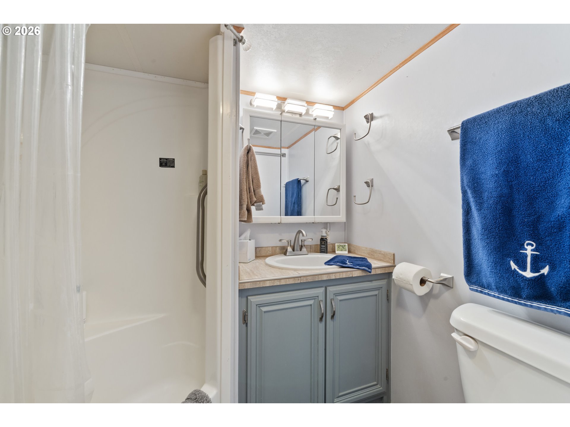 37395 North Fork Road, Unit 13 Nehalem, OR 97131 - Photo 19 of 34 a bathroom with a sink vanity granite and a mirror