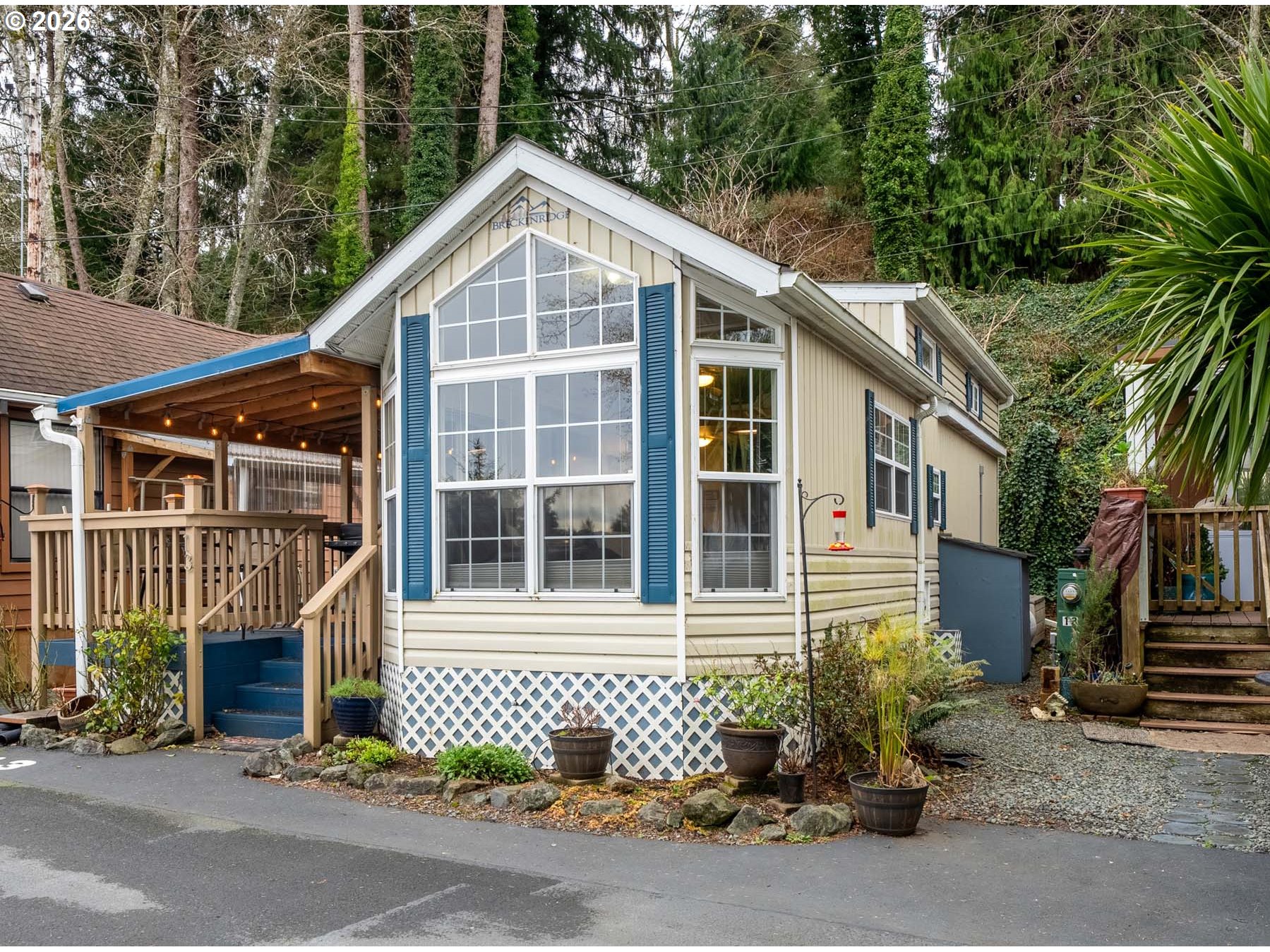 37395 North Fork Road, Unit 13 Nehalem, OR 97131 - Photo 2 of 34 a front view of a house with a garden
