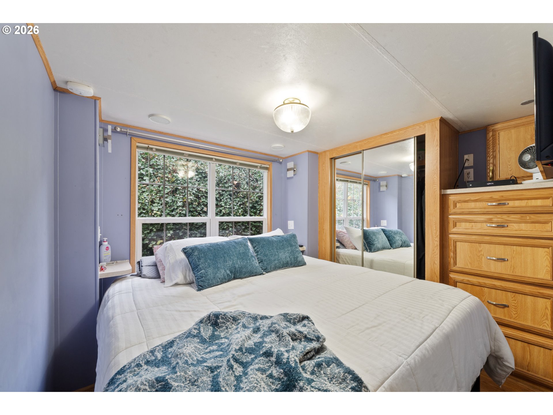 37395 North Fork Road, Unit 13 Nehalem, OR 97131 - Photo 21 of 34 a bedroom with a bed and a dresser