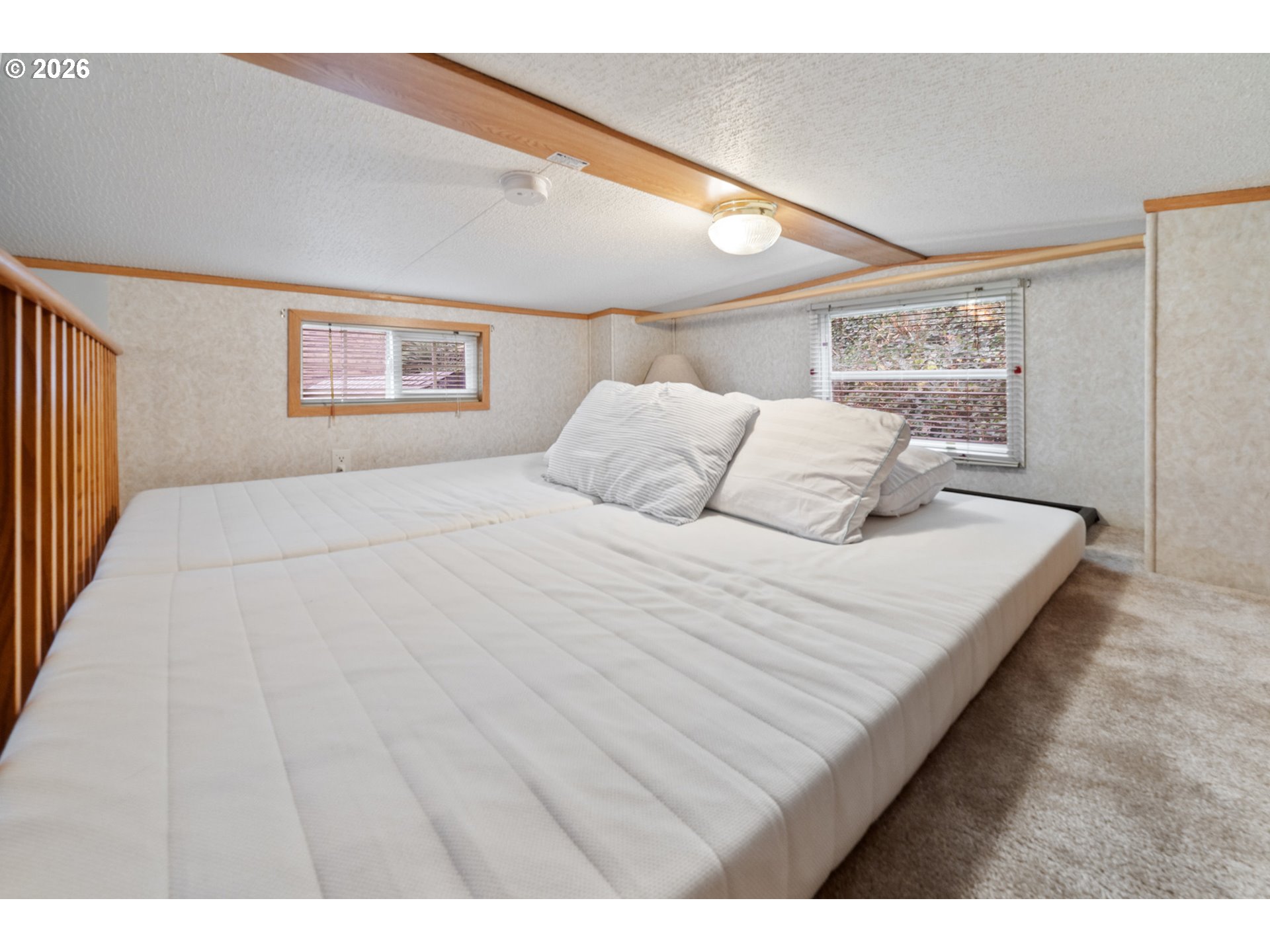 37395 North Fork Road, Unit 13 Nehalem, OR 97131 - Photo 24 of 34 a bedroom with a bed and a night stand
