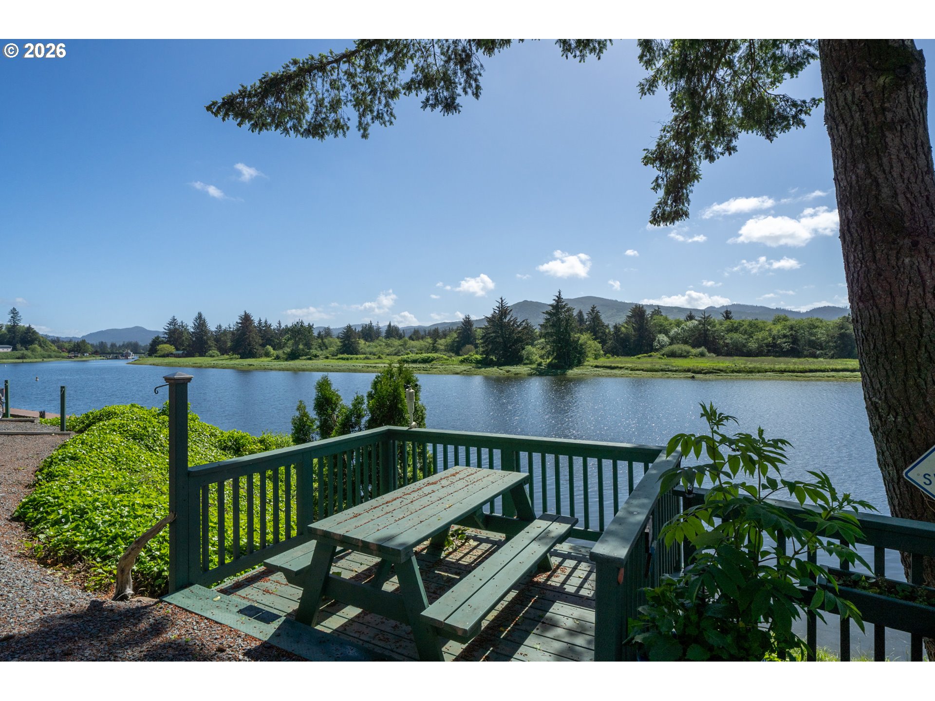 37395 North Fork Road, Unit 13 Nehalem, OR 97131 - Photo 31 of 34 a view of a deck with two chairs and a table