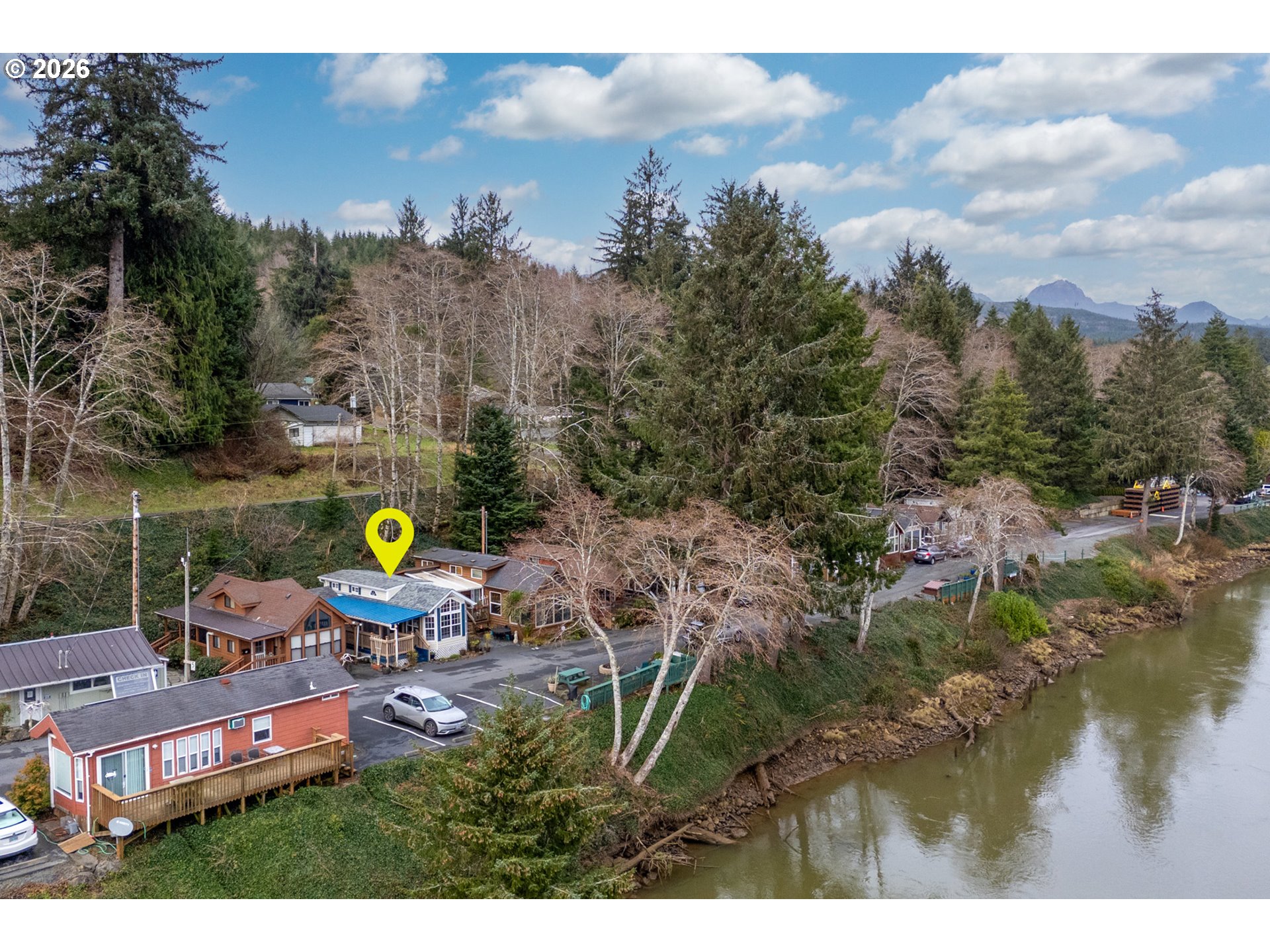 37395 North Fork Road, Unit 13 Nehalem, OR 97131 - Photo 34 of 34 a wooden bench sitting in the middle of a lake