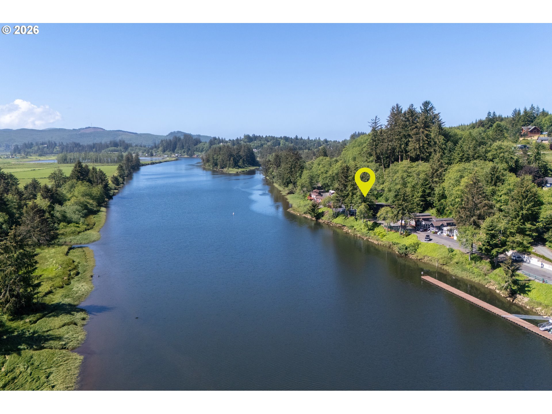 37395 North Fork Road, Unit 13 Nehalem, OR 97131 - Photo 8 of 34 a view of a lake with a house in the background