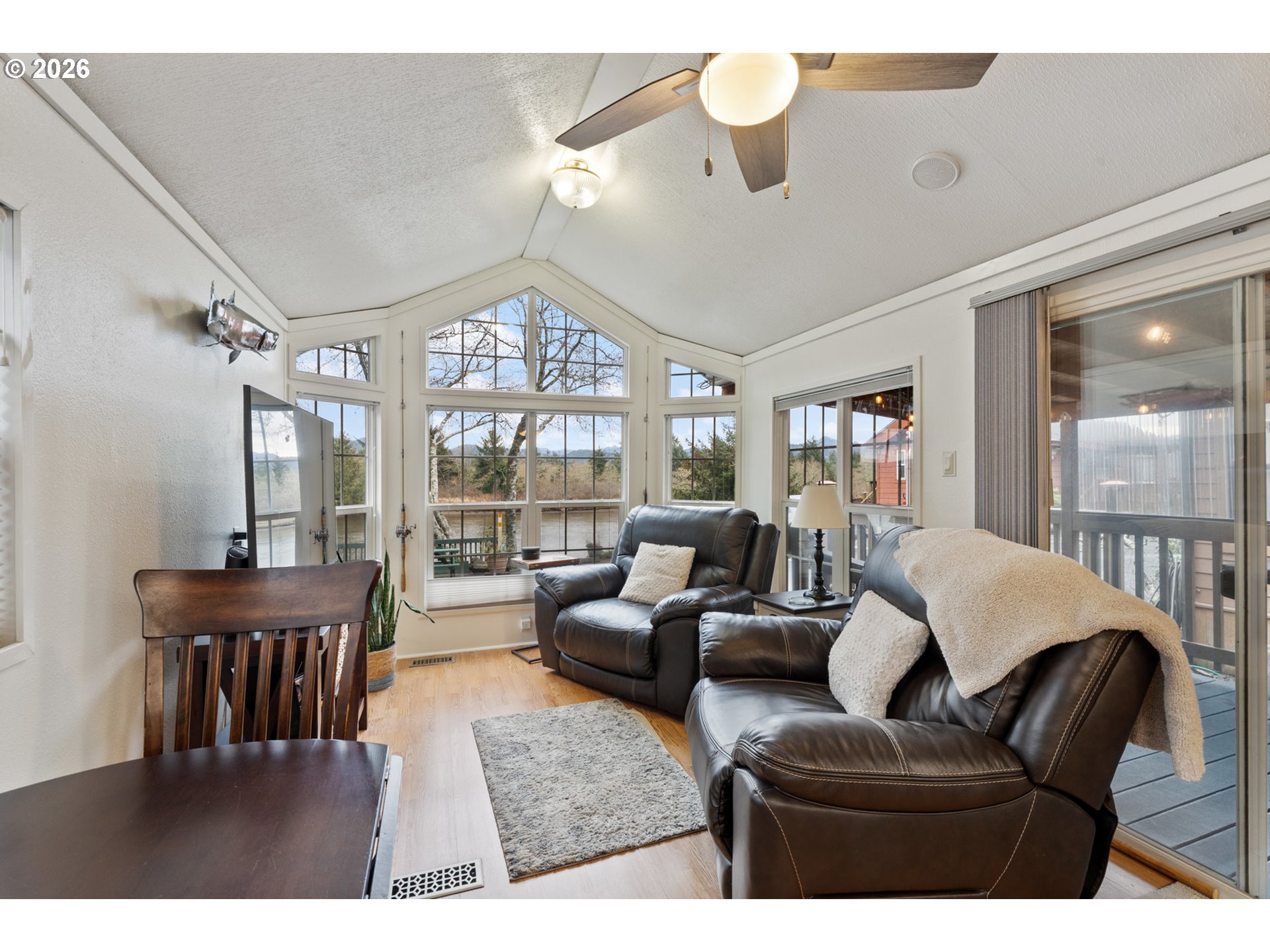 37395 North Fork Road, Unit 13 Nehalem, OR 97131 - Photo 9 of 34 a living room with furniture dining area and a large window